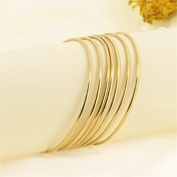 Bracelets ANJALI – Semainier de 7 joncs dorés